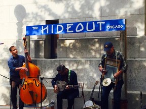 This Aug. 25, 2015 photo shows Devil in a Woodpile, a rootsy jug band-like group, performing at The Hideout's outpost along Chicago's Riverwalk. The spot is an upscale version of the Hideout's  beloved music venue and bar's divey Northwest Side location, and offers al fresco free music and cheap drinks until Nov. 1. (AP Photo/Lindsey Tanner)