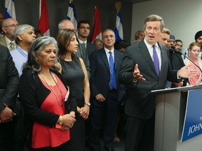 Toronto Mayor John Tory  is surrounded by religious leaders after they met Thursday, Sept. 10, 2015 to discuss how the city will help with the migrant crisis. (VERONICA HENRI/Toronto Sun)