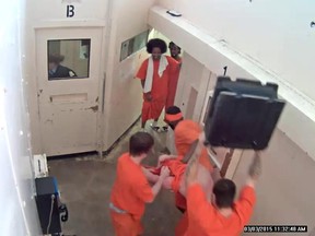This surveillance video screengrab from the Ottawa Carleton Detention Centre shows the beating of Carlos Larmond, an Ottawa man who was arrested on terror-related charges. Terrence Wilson, 23, pleaded guilty to assault causing bodily harm. Michael Clarke, 29, still faces assault charges in the incident. (Video screengrab Ottawa Sun / Postmedia Network