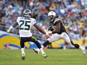 Seahawks cornerback Richard Sherman (left) attempts to tackle Chargers running back Melvin Gordon (right) during NFL preseason action at Qualcomm Stadium in San Diego on Aug. 29, 2015. (Orlando Ramirez/USA TODAY Sports)