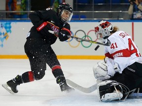 REFILE - CORRECTING ID OF CANADIAN PLAYER 

Canada's Jayna Hefford (L) shoots on Switzerland's goalie Florence Schelling during the first period of their women's ice hockey game at the 2014 Sochi Winter Olympics, February 8, 2014. REUTERS/Jim Young (RUSSIA  - Tags: SPORT OLYMPICS SPORT ICE HOCKEY)