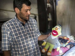 Father of Aylan Kurdi (also know as Aylan Shenu), a three-year-old boy whose drowning off Turkey, Abdullah Kurdi stands in Aylan's room on September 6, 2015 in Kobane. Aylan Kurdi was buried with his four-year-old brother and mother on September 4 in Kobane. They had been living in Damascus but were forced to flee the war's instability which has left more than 240,000 people dead, more than four million have sought refuge in nearby countries, and millions more have been internally displaced. AFP PHOTO / YASIN AKGUL