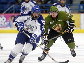 Sudbury Wolves Nicholas Romero controls the puck while being pursued by North Bay Battalion Zach Poirier during OHL exibition action from the Sudbury Community Arena on Sunday September 6/2015. Romero is one of the rookie hopefuls who remains in camp with the Wolves.