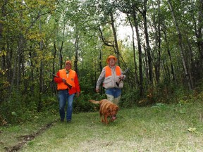 Emmerson Dober (L), Neil and his fox red Lab Penny on a season opener grouse hunt.