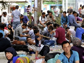 Migrants rest at a square in central Athens after arriving on passenger ships at the port of Piraeus from Lesbos island, Greece, September 10, 2015. (REUTERS/Michalis Karagiannis)