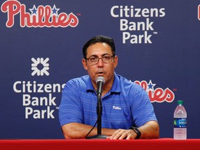 In this July 31, 2015, file photo, Philadelphia Phillies general manager Ruben Amaro Jr. takes questions from the media after trading starting pitcher Cole Hamels to Texas. (AP Photo/Chris Szagola, File)