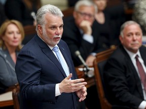 Quebec's Premier Philippe Couillard, seen here speaking during a tribute to late former Quebec's Premier Jacques Parizeau in June, is going to sponsor a Syrian refugee family with the help of others in his riding north of Quebec City. REUTERS/Mathieu Belanger