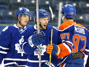 Toronto Maple Leafs forwards Mitchell Marner and Connor Brown joke with Edmonton Oilers forward Connor McDavid during the NHLPA rookie showcase in Toronto on Tuesday September 1, 2015. (Dave Abel/Toronto Sun/Postmedia Network)