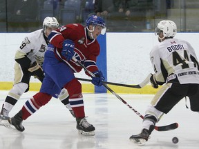 Kingston Voyageurs' Danny Bosio tries to get past Trenton Golden Hawks' Nick Boddy during Ontario Junior Hockey League season-opening action at the Invista Centre on Thursday night. Trenton won 3-1. (Ian MacAlpine/The Whig-Standard)