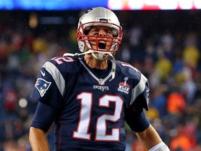 Tom Brady of the New England Patriots cheers as he runs on to the field before the game against the Pittsburgh Steelers at Gillette Stadium in Foxboro, Mass. on September 10, 2015. (Jim Rogash/Getty Images/AFP)