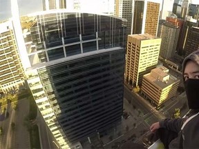Joseph McGuire atop the crane at the Eau Claire Tower construction site in downtown Calgary. (Epinerein /YouTube screengrab)