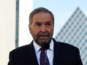 NDP leader Tom Mulcair answers media questions after delivering a statement in downtown Edmonton on Friday, September 11, 2015. THE CANADIAN PRESS/Sean Kilpatrick