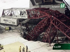 In this still image taken from video released by Saudi TV, a crane is seen collapsed over the Grand Mosque in Mecca, killing dozens, Friday, Sept. 11, 2015. The accident happened as pilgrims from around the world converged on the city, Islam's holiest site, for the annual Hajj pilgrimage, which takes place this month. (Saudi TV via AP)