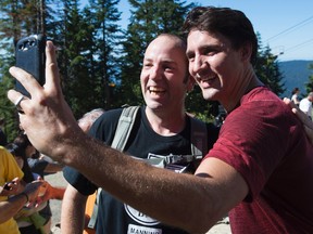 Liberal Leader Justin Trudeau takes a selfie with a supporter after climbing the Grouse Grind during an election campaign stop in North Vancouver, B.C. on  Friday. (THE CANADIAN PRESS)