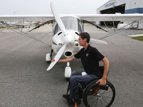 Zach Elliott turns the prop on his ultralight aircraft at the airport in Kingston, Ont. on Tuesday, Sept. 8, 2015. Elliott is set to open his flight training school on Saturday, two years after being paralyzed in a car crash. Elliot Ferguson/Kingston Whig-Standard/Postmedia Network