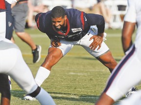 Arian Foster, stretching it out during training camp, could be back sooner than expected. (AP)
