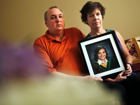 Gordon Stringer, left, and his wife, Kathleen Stringer, pose with a framed portrait of their daughter, Rowan, Thursday, May 16, 2013, who died after a head injury suffered while playing high school rugby last week.  Darren Brown/Ottawa Sun/QMI Agency
