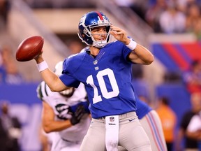 Eli Manning has re-signed for four more years with the New York Giants.  Elsa/Getty Images/AFP