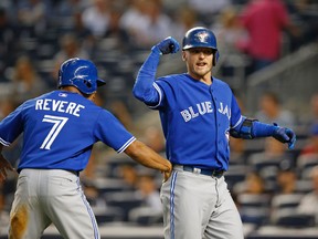 Toronto Blue Jays' Ben Revere (7) celebrates with Josh Donaldson after scoring on Donaldson's first-inning, two-run, home run off New York Yankees starting pitcher Luis Severino in a baseball game at Yankee Stadium in New York, Friday, Sept. 11, 2015. (AP Photo/Kathy Willens)