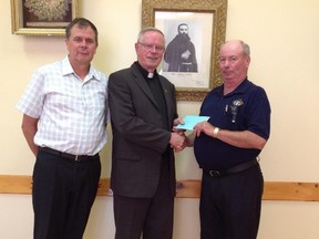 Shown presenting the donation is Grand Knight Joe Ryan on right along with council 5289 treasurer Gerry Van den Hengel to the left and Rev. John Van den Hengel in the middle.(Contributed photo)