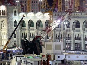 A towering construction crane, center, is seen collapsed over the Grand Mosque, in Mecca, Saudi Arabia, early Saturday morning, Sept. 12, 2015. (AP Photo)