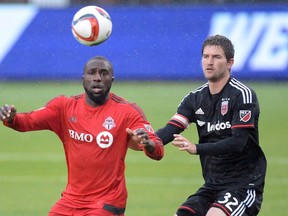 Toronto FC forward Jozy Altidore, left, battles for the ball with D.C. United defender Bobby Boswell during second half MLS soccer action in Toronto on June 27, 2015. (THE CANADIAN PRESS/Frank Gunn)