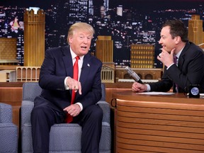 In this image released by NBC, Republican presidential candidate Donald Trump, left, appears with host Jimmy Fallon during a taping of "The Tonight Show Starring Jimmy Fallon," on Friday, Sept. 11, 2015, in New York. (Douglas Gorenstein/NBC via AP)