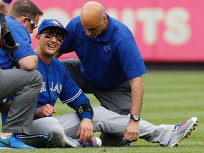 Toronto Blue Jays staff tend to Toronto Blue Jays shortstop Troy Tulowitzki after he collided with Kevin Pillar fielding a fly ball in the second inning at Yankee Stadium in New York on Sept. 12, 2015. (AP Photo/Kathy Willens)