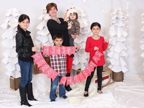 Mom Alison Azer, holds Meitan as her other children Sharvahn, left to right, Dersim and Rojevahn pose for photo in this family handout image. Police are searching for four Vancouver Island children allegedly abducted by their father overseas. (THE CANADIAN PRESS/HO)