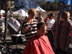 Shad Turner gets a free solar-powered buzz cut from Paula Stenson at 10150 104 Street as part of Greenpeace's Get Fresh Alberta campaign. The haircuts were given in exchange for filling out the province's survey on climate. Catherine Griwkowsky/Edmonton Sun