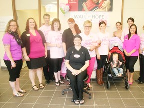 Employees at CIBC’s Goderich branch are rallying around co-worker Michele Bouck (seated) who was diagnosed with breast cancer in March. The branch is entering the Run for the Cure event on October 4 for the first time in honour of Michele. (Dave Flaherty/Goderich Signal Star)