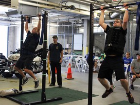 Kingston Fire and Rescue's Tom Meers (on left) and Military Police's Patrick Fagan compete at the Kingston Police's Unbreakable We Are competition for the Make a Wish Foundation Kingston, Ont. on Saturday September 12, 2015. Steph Crosier/Kingston Whig-Standard/Postmedia Network