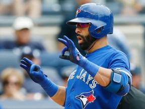Toronto Blue Jays Jose Bautista gestures crossing the plate on his game-tying solo home run in the eighth inning of the Blue Jays 9-5, 11-inning, victory over the Toronto Blue Jays in the first baseball game of a doubleheader at Yankee Stadium in New York, Saturday, Sept. 12, 2015. It was Bautista's second home run of the game. (AP Photo/Kathy Willens)