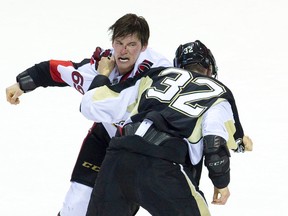 Ottawa Senators forward Max McCormick and Pittsburgh Penguins defenceman Harrison Ruopp fight near the end of the third period during their NHL Rookie Tournament hockey game at Budweiser Gardens in London, Ont. on Saturday Sept. 12, 2015. 
Craig Glover/Postmedia Network
