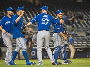 Toronto Blue Jays teammates congratulate Toronto Blue Jays pitcher Mark Lowe (57) after getting the save against the New York Yankees at Yankee Stadium.  The Blue Jays won 10-7. (Gregory J. Fisher/USA TODAY Sports)