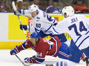 Montreal Canadiens forward Jeremiah Addison chases down a loose puck while under pressure from Toronto Maple Leafs forwards Carter Verhaeghe (60) and Michael Joly (74) during their NHL Rookie Tournament hockey game at Budweiser Gardens in London, Ont. on Saturday September 12, 2015. (Craig Glover/The London Free Press/Postmedia Network)