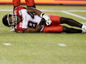 Calgary Stampeders Frank Beltre (94) lies injured on the field against the Edmonton Eskimos during first half action in Edmonton, Alta., on Saturday September 12, 2015. THE CANADIAN PRESS/Jason Franson.