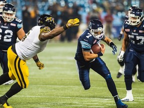 Toronto Argonauts' Trevor Harris makes some ground against the Hamilton Tiger-Cats during first half CFL action in Toronto on Friday, September 11, 2015. THE CANADIAN PRESS/Aaron Vincent Elkaim