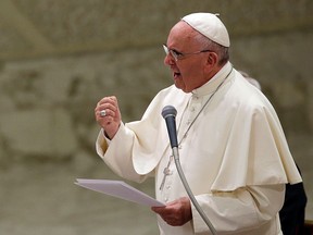 Pope Francis delivers his message during an audience with faithful and employees of the Rome's Cooperative Credit Bank in the Paul VI hall at the Vatican, Saturday, Sept. 12, 2015. To some Republican presidential candidates, it’s better to be with the popular pope than against him. (AP Photo/Gregorio Borgia)