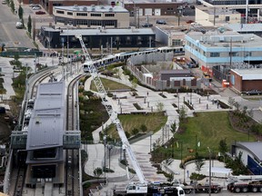 Up and running. A train heads north towards NAIT after leaving the MacEwan Station as another train sitting in the station heading downtown, viewed from the 16th floor of the Epcor Tower on Tuesday Sept 8, 2015. After many delays in the system, the Metro Line finally started service. Tom Braid/Edmonton Sun/Postmedia Network.