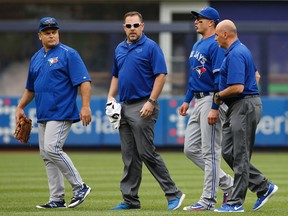 Toronto Blue Jays manager John Gibbons looks back as team staff escort shortstop Troy Tulowitzki off the field after he collided with Kevin Pillar fielding a second-inning fly ball at Yankee Stadium in New York on Sept. 12, 2015.  (AP Photo/Kathy Willens)