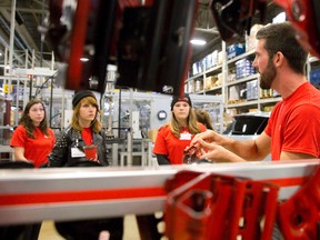 Brose technical leader Matt Cooper talks to a group of people as they tour the auto-parts supplier during their 10th anniversary open house in London. Family and friends of employees, along with suppliers, were invited to the celebration which featured tours, entertainment, displays, food and games. (CRAIG GLOVER, The London Free Press)