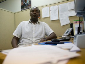 Deeq Abdi, executive director of the African Community Council, reviews a letter about the loss of federal funding for his London organization. (CRAIG GLOVER, The London Free Press)