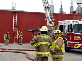 Employees at the Cooper Standard Automotive plant in Mitchell waited outside as West Perth and Perth East firefighters extinguished a fire that started in the plant's dip room in the late morning of Saturday, Sept. 12. GALEN SIMMONS/MITCHELL ADVOCATE
