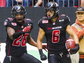 Redblacks DB Antoine Pruneau (6) celebrates an interception against the B.C Lions with teammate Jacques Washington (28) during the second half of their CFL football game in Vancouver on September 13, 2015. 
REUTERS/Ben Nelms