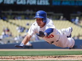 Los Angeles Dodgers' Darwin Barney slides back to first base during the sixth inning of a baseball game against the Washington Nationals in Los Angeles on Sept. 3, 2014. (THE CANADIAN PRESS/AP/Jae C. Hong)