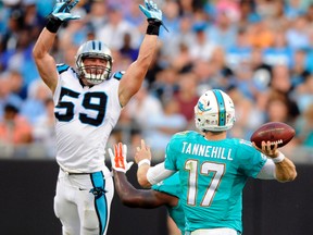 Panthers' Luke Kuechly (left) sustained a concussion on a helmet-first tackle on Sunday against the Jaguars. (AP/PHOTO