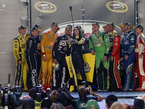 The 16 NASCAR Sprint Cup drivers who qualified for the Chase for the Sprint Cup pose for a selfie with Miss Sprint Cup Juliana White after the race in Richmond, Va., on Saturday. To see how White’s photo turned out, visit twitter.com/MissSprintCup. (BRIAN LAWDERMILK/Getty Images/AFP)