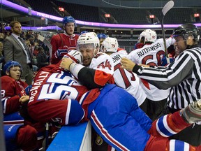 Ottawa Senators forward Travis Ewanyk dumps Montreal Canadiens forward Brendon McNally into the Montreal bench as several fights break out after the end of the first period during their NHL Rookie Tournament hockey game at Budweiser Gardens in London, Ont. on Sunday September 13, 2015. Craig Glover/The London Free Press/Postmedia Network