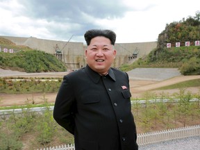North Korean leader Kim Jong Un smiles during his visit to the construction site of the Paektusan Hero Youth Power Station near completion in this undated photo released by North Korea's Korean Central News Agency (KCNA) in Pyongyang September 14, 2015.  REUTERS/KCNA
